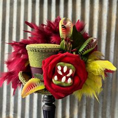 FEED ME!  Cute and creepy mini top with an polyester like shantung looking green fabric.  A bouquet of venus flytraps and a big ol' people eating rose in the front.  Perfect for Halloween! ----------------------------------------------------------------------------------------- A comfortable elastic band of your choice of color is attached. I find that the elastic band really keeps these little hats on your head and is, in my opinion, the most comfortable to wear and the most versatile. With the elastic you have your choice of wearing it on the right or left side of your head or directly in the center. See this listing for how my hats go on. https://www.etsy.com/listing/186224360/example-and-demonstration-of-how-my-hats?ref=shop_home_active_23 ---------------------------------------------- Alice In Wonderland Mad Hatter, Wonderland Mad Hatter, Venus Flytrap, Mad Hatter Hat, Blusher Veil, Little Shop Of Horrors, Mini Top Hat, Venus Fly Trap, Mini Top