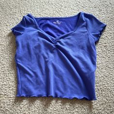 This Hollister Shrunken Cropped Tee Is Never Worn And Is In Great Condition With No Rips Or Stains. It’s A Purple/Blue Color And A Size Small. Trendy Stretch Purple T-shirt, Trendy Purple Stretch T-shirt, Purple Stretch Crew Neck Top, Y2k Style Stretch Blue Tops, Y2k Short Sleeve Blue Top, Blue Y2k Crop Top, Purple Stretch Crop Top, Blue Y2k Short Sleeve Top, Y2k Blue Short Sleeve Top