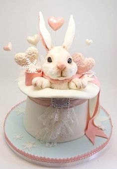 there is a cake that looks like a rabbit in a hat with hearts on it