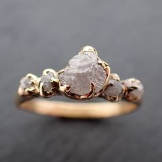 a close up of a gold ring with white stones