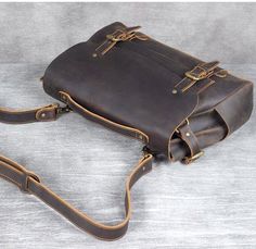 a brown leather bag sitting on top of a table