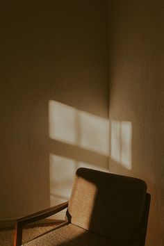 a chair sitting in front of a window with the sun shining on it's side