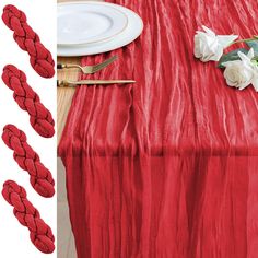 red table cloth with white flowers on it and place settings next to the tablecloth