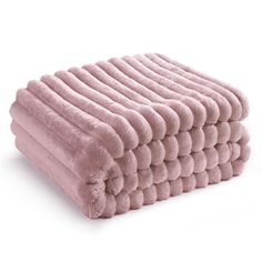 pink towels stacked on top of each other