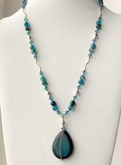 The colors of this necklace are the most beautiful shades of teal and aqua! The beads vary in intensity from a very light blue to a dark teal. The tear drop pendant has a very simple sterling silver wire wrap. I added 6mm Bicone aqua zircon Swarovski crystals for a touch of sparkle against the opaque stones. The round 7mm sterling silver beads and curved tube beads add elegance and movement to the design. This necklace will be perfect with neutrals, black, aqua ir print dresses or tunics. The be Elegant Pearl Jewelry, Tear Drop Pendant, Swarovski Crystal Jewelry, Necklace Ideas, Crystal Bead Necklace, Crystal Necklaces, Swarovski Crystal Necklace, Sterling Silver Wire Wrap, Long Beaded Necklace