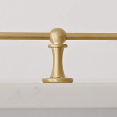 a gold handle on a white counter top