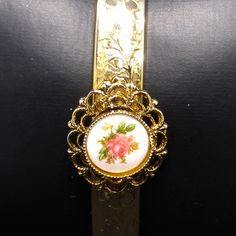 *Description: This is a beautiful repousse gold plated hinged bracelet with a filigree circular porcelain hand painted pink rose accent piece on the top of the bracelet. The bracelet looks beautiful and the gold is bright and shiny. It would make a great vintage gift or a wonderful addition to your vintage jewelry collection. *Approximate Measurements: Length around inside - 6 1/2 Inches, Width - 5/8 Inch *Condition: Great vintage condition. Will see signs of wear under magnification. *Hallmark: Vintage Rose Gold Jewelry From Vintage Collection, Vintage Rose Gold Jewelry For Vintage Collection, Antique Gold Jewelry With Rose Design, Vintage Enamel Jewelry With Filigree Details, Vintage Gold Enamel Bracelets, Vintage Enamel Jewelry With Filigree, Vintage Hinged Bracelets For Gift, Vintage Rose Gold Bracelet For Gift, Vintage Rose Design Jewelry For Formal Occasions