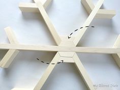 the wooden snowflake is cut into four sections