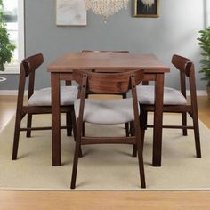 a dining room table with four chairs around it