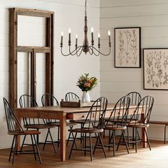 a dining room table with chairs and chandelier