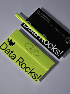 two business cards with the words data rocks written in black and green on each one