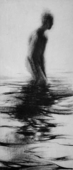 a black and white photo of a person in the water