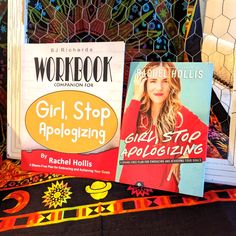 two books sitting next to each other on top of a bed covered in colorful blankets