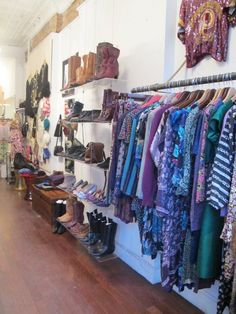 there are many pairs of shoes hanging on the wall in this shop, and one pair is also being used as a shoe rack