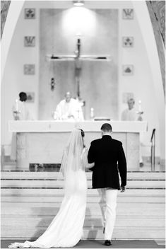 a bride and groom walking down the aisle at their wedding ceremony in black and white