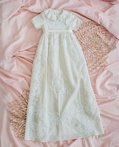 Blessed For Generations to Come Transform your own wedding gown fabric and its exquisite embellishments into a treasured family keepsake. This exquisite, one-of-kind, Christening or Baptism Gown is custom designed and hand constructed with attention to detail. Features: Embellished bodice and skirt Fully lined gown Velcro back closure Satin ribbon belt Artisan crafted for exquisite handiwork detail Matching bonnet option available Give the gift that wraps baby in love in the most special way possible. See photos for product silhouette. Final designs will vary based on your wedding gown. Months Height Chest 0-3 23" 18" 3-6 25" 19" 6-9 28" 20" 9-12 32" 21" 12-18 33.5" 21.5" 18-24 35" 22" Baptism Gown, Christening Gown, Ribbon Belt, Family Keepsakes, Christening Gowns, Artisan Craft, Satin Ribbon, Wedding Gown, New Baby