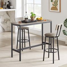 a kitchen table with two stools next to it