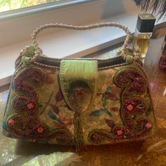 Authentic Mary Frances Handbag. It Is In Good Condition, No Stains Or Pulls. The Handle Is The Only Issue. The Strand Of Beads Pulled But Can Be Fixed Or Tied Off And Cut. Still A Lot Of Wear To This Bag. I Loved It Very Much Just Time To Rotate The Closet Designer Embellished Rectangular Shoulder Bag, Designer Embellished Bags For Shopping, Green Pouch Satchel For Evening, Designer Embellished Rectangular Bag, Elegant Multicolor Handheld Satchel, Elegant Green Satchel For Party, Vintage Green Shoulder Bag For Party, Vintage Embellished Rectangular Bag, Green Vintage Shoulder Bag For Party