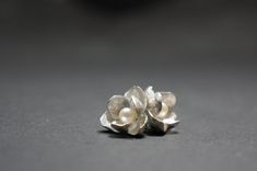 -Product description- Handmade sterling silver (925) jasmine earrings. The inner surface of the petal was carefully hand textured to be shimmery. While the outer layer was smooth and shiny, to give a beautiful contrast. A freshwater pearl was then attached to give an elegant touch. Great as a gift for her, or a treat for yourself. It is about 17mm (11/16 inch) in diameter, weighing 3.3 g (0.12oz). The ear post is 11mm(7/16 inch). Ear post can be customized to ear wire upon request. Please feel f Silver Pearl Drop Flower-shaped Earrings, Delicate Silver Petal Earrings, Delicate Silver Flower Earrings For Anniversary, Silver Sterling Flower Earrings With Pearl Drop, Silver Flower Earrings With Pearl Drop, Silver Sterling Pearl Drop Flower Earrings, Silver Pearl Drop Earrings In Flower Shape, Silver Flower Shape Pearl Drop Earrings, Silver Petal-shaped Earrings For Gift