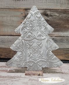 a white ceramic christmas tree sitting on top of a wooden table