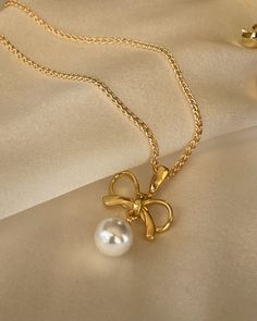 The Cosette Bow Necklace is dainty and sweet. Inspired by a vintage style and pairs well with matching earrings. 18kt gold plated silver bow and pearl the dangles. 22mm in length. Golf filled chain 16 or 18 inches. Pita Aesthetic, Pearl Bow, Bow Necklace, Silver Bow, Elegant Accessories, Gold Plated Silver, Pita, Matching Earrings, Vintage Style