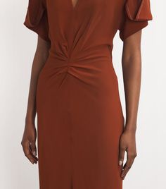 Find VICTORIA BECKHAM Gathered V-neck Midi Dress on Editorialist. Victoria Beckham excels at elevating classic silhouettes with minute detailing, an ability that comes to the fore with this midi dress. Imagined with gathered detailing to the front and draped sleeves, its complemented with white topstitching to highlight the label's beautiful sartorial ability. Brown Silk V-neck Dress, Elegant Brown Ruched Midi Dress, Elegant Ruched V-neck Dress With Short Sleeves, Classic Silk V-neck Dress, Brown Silk V-neck Midi Dress, Formal Brown Ruched Midi Dress, Evening V-neck Midi Dress With Structured Shoulders, Elegant Brown Short Sleeve Midi Dress, Brown V-neck Midi Dress For Cocktail