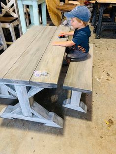 a young boy sitting at a wooden table