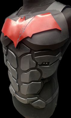 the back of a batman costume with a red bat on it's chest and chest