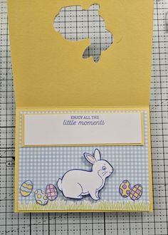 a card with an image of a bunny and eggs on it, in the shape of a cutout