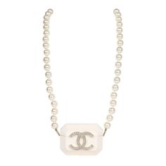 This Chanel resin crystal pearl Airpod Pro case necklace is crafted from resin material with a large gold and crystal CC on the front of the Airpod case. The case features a long single strand of pearls and an interwoven chain of light gold tone and black lambskin leather to be worn as a strap or a necklace. This necklace also features an opening on the base for a charging cord.Collection: 2021Origin: ItalyCondition: New and never wornAccompanied by: Chanel pouch, ribbon and carebookMeasurements Chanel Pouch, Airpod Pro Case, Airpod Pro, Charging Cord, Airpod Case, Resin Material, Gold Diamond Rings, Crystal Pearls, Lambskin Leather