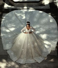 a woman in a wedding dress is standing on the ground