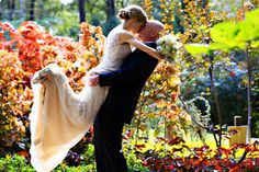 a bride and groom embracing in the garden