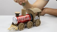 a kid playing with a toy coca cola train