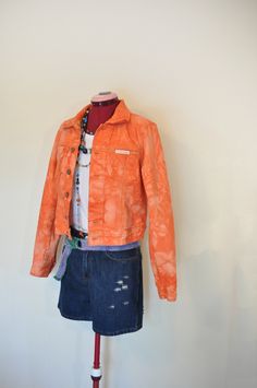 Item # 210579 DETAILS: Upcycled Orange Denim Jacket. This jacket is a size  "Calvin Klein" brand,  100% Cotton Trucker Style Jacket dyed orange.  It is a 6 blue button trucker jacket with 2 flap front breast pockets and button cuff sleeves.  Boys Size Medium Measurements:  15" across the shoulders,  19" from collar seam to hem,  18" from armpit to armpit (36" chest) 17" at the waistline, (34" waist) 25" sleeve length.  38 cm across the shoulders,  48 cm from collar seam to hem,  46 cm from armpit to armpit (92 cm chest) 43 cm at the waistline, (86 cm waist) 64 cm sleeve length.  Jacket sizes may vary. I recommend that you measure a jacket that you have and compare the measurements.  The jacket has been dyed with fabric dye and will not rub off onto other clothing. The jacket has been washe Acid Wash Cotton Denim Jacket, Fitted Faded Cotton Outerwear, Spring Outerwear Relaxed Fit Pre-washed, Spring Outerwear: Pre-washed Relaxed Fit, Spring Relaxed Fit Pre-washed Outerwear, Fitted Acid Wash Cotton Outerwear, Casual Fitted Pre-washed Denim Jacket, Orange Denim Jacket, Calvin Klein Denim