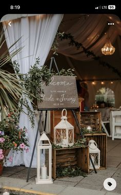 a sign that says welcome to the guests at a wedding reception with candles and flowers