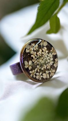 Welcoming a little piece of nature for someone unerring! Enjoy this pressed Queen Anne's Lace Ring pressed before encapsulating them with resin. Ring Measures, Tray: 16mm, 5x17mm Pendant Measures: Oval Tray: 25x18mm, 42.5x23.5x2mm, Hole: 3mm The Antique Bronze ring is adjustable and comes in a beautifulgift box.. All Jewelry findings are Lead and Nickel free. The petals have been carefully preserved to retain their color and would make a great gift for your loved ones. This piece was made with r Nature-inspired Brown Flower-shaped Jewelry, Unique Copper Flower Jewelry, Adjustable Gold Flower Ring Nature-inspired, Adjustable Gold Flower Ring, Nature-inspired, Nature-inspired Gold Flower Ring With Birth Flower, Brown Flower-shaped Jewelry Gift, Nature-inspired Gold Birth Flower Ring, Bohemian Brown Flower Jewelry, Vintage Silver Jewelry With Pressed Flowers