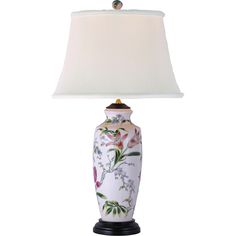 a lamp that is on top of a white base with flowers and leaves painted on it