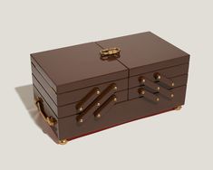 a large brown box with gold handles and latches