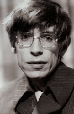 a black and white photo of a man wearing glasses