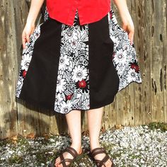 "Here is a classy looking black, white and red knee length skirt for women. Made with two coordinating cotton fabrics, this handmade a-line skirt is perfect for many different occasions! This skirt has 8 panels alternating between a solid black fabric and a white print with black outlined flowers and bold red accents here and there to add a little bit of color. Depending on the look you want, a black, white, or red top would all look great with this Summer skirt This skirt has an elastic waistba Black Cotton Skirt With Gathered Details, Red Cotton Midi Skirt, Black Cotton Flared Skirt, Red Cotton Flared Skirt, Black Cotton Knee-length Skirt, Red Flared Cotton Skirt, Black Knee-length Cotton Skirt, Black A-line Retro Skirt, Black Retro A-line Skirt