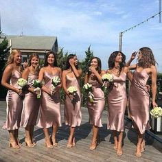 a group of women standing on top of a wooden deck