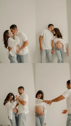 a man and woman kissing while standing next to each other in front of a white wall