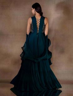 Dark green corset gown featuring a hand embellished part-sheer bodice & a flowy bottom with two gathered tiers. Paired with a metal buckled belt & an organza georgette combination dupatta.From Shloka Khialani's Winter Sun collection.DELIVERY TIMEPlease allow 6-8 weeks for your outfit to arrive.FABRIC DETAILSGeorgette, Organza, CrepeProfessional cleaning only. Fitted Gown With Sheer Bodice In Georgette, Fitted Georgette Gown With Sheer Bodice, Silk Chiffon Wedding Gown With Fitted Bodice, Silk Chiffon Maxi Wedding Gown, Silk Chiffon Wedding Gown In Maxi Length, Silk Chiffon Floor-length Wedding Gown, Floor-length Silk Chiffon Wedding Gown, Floor-length Georgette Dress With Sheer Bodice, Wedding Dress With Sheer Sleeves In Georgette