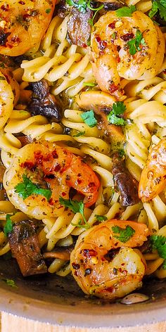 pasta with shrimp, mushrooms and parsley in a skillet ready to be eaten