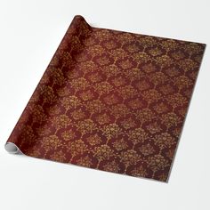 a red and gold wallpaper with golden flowers on it