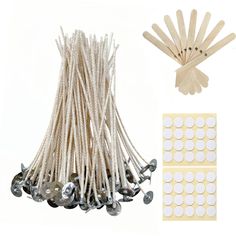 wooden pegs and white stickers are next to a bunch of pins on a white background