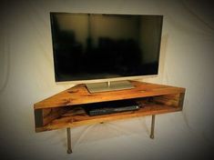 a wooden entertainment center with a flat screen tv mounted on it's side wall