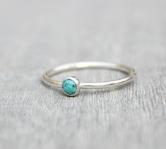 Beautiful December birthstone stacking ring. Made in .925 sterling silver and stone is a 3mm genuine turquoise. This ring is made to order in your size. If you don't see your size available please feel free to message me. All orders ship in a gift box. If you are ordering multiple items and want them boxed separately, please let me know in the notes at checkout. I ship via USPS. Please review the estimated delivery date and processing times. Processing times vary based on how busy my shop is at Turquoise Stackable Dainty Jewelry, Adjustable Sterling Silver Turquoise Birthstone Ring, Dainty Turquoise Stackable Ring, Minimalist Adjustable Turquoise Ring For Everyday, Turquoise Gemstone Stackable Rings In Sterling Silver, Dainty Blue Turquoise Stackable Ring, Stackable Turquoise Ring Gift, Dainty Turquoise Sterling Silver Ring, Minimalist Stackable Turquoise Ring