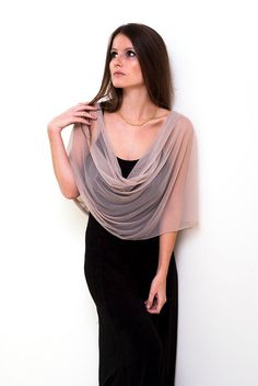 Step into a world of understated elegance with our Beige Sheer Loop Shawl - a captivating and lightweight accessory that effortlessly enhances your look in four different ways: as a shrug, shawl, crisscrossed shawl, or scarf. The versatile beige hue combined with sheer fabric exudes sophistication, making it a perfect choice for various occasions. Available in three sizes for a flawless fit: Petite (US 0-6) One size (US 8-14) Plus size (US 14-22) This exquisite shawl comes with wearing instructions, beautifully presented in a printed gift bag, making it a thoughtful and charming gift option for your loved ones. Additionally, we've thoughtfully included a QR code linked to the movie clip, granting you easy access to styling ideas. Experience the elegance in our YouTube clip: http://www.yout Pink Shawl, Sheer Cover Up, Shrug For Dresses, Evening Shawls, Bridal Bolero, Beige Stone, Shrugs And Boleros, Bridal Shawl, Loop Scarf