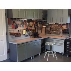 a kitchen with grey cabinets and gray stools